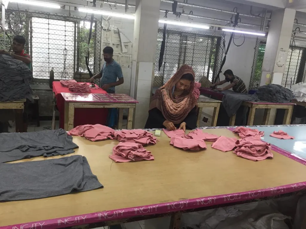 Finished red garment batch on the sewing floor